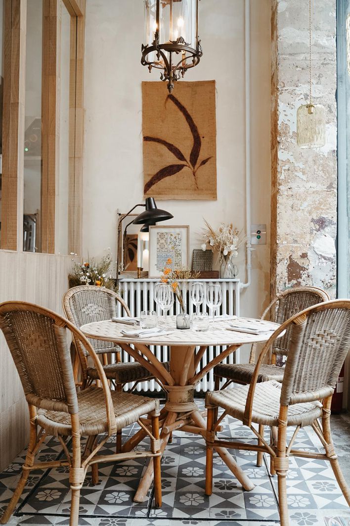 L'Avant-Poste restaurant's bohemian farmhouse style interiors with bamboo chairs.